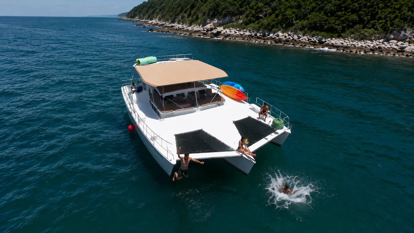 Beach Anchor & The Water Drop anchor at a quiet beach where the two dive platforms mean no queue to get in and out. Snorkel, paddleboard or use the lily pad, with the open bar flowing. The 6 hour adds a chef made lunch served on deck