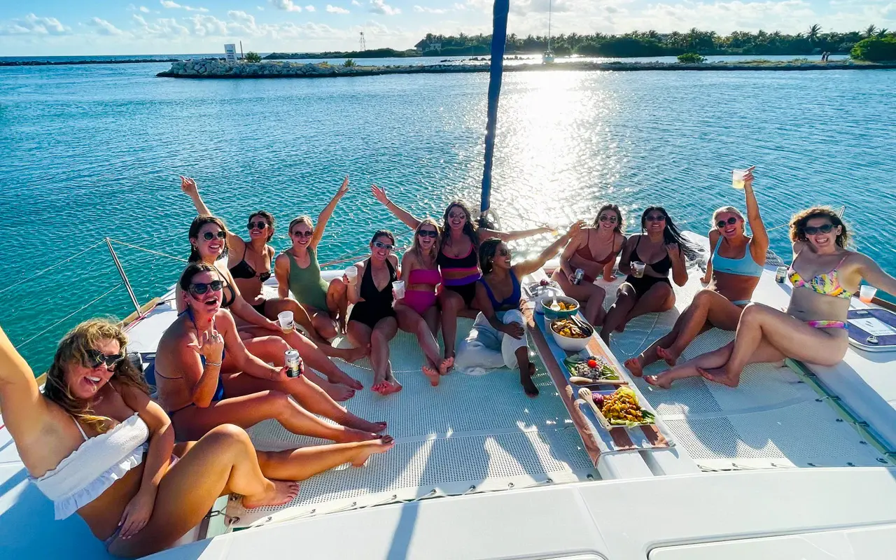 Return to Puerto Aventuras Cruise back with open bar, sunbathing on the trampoline sundeck, disembark at the marina